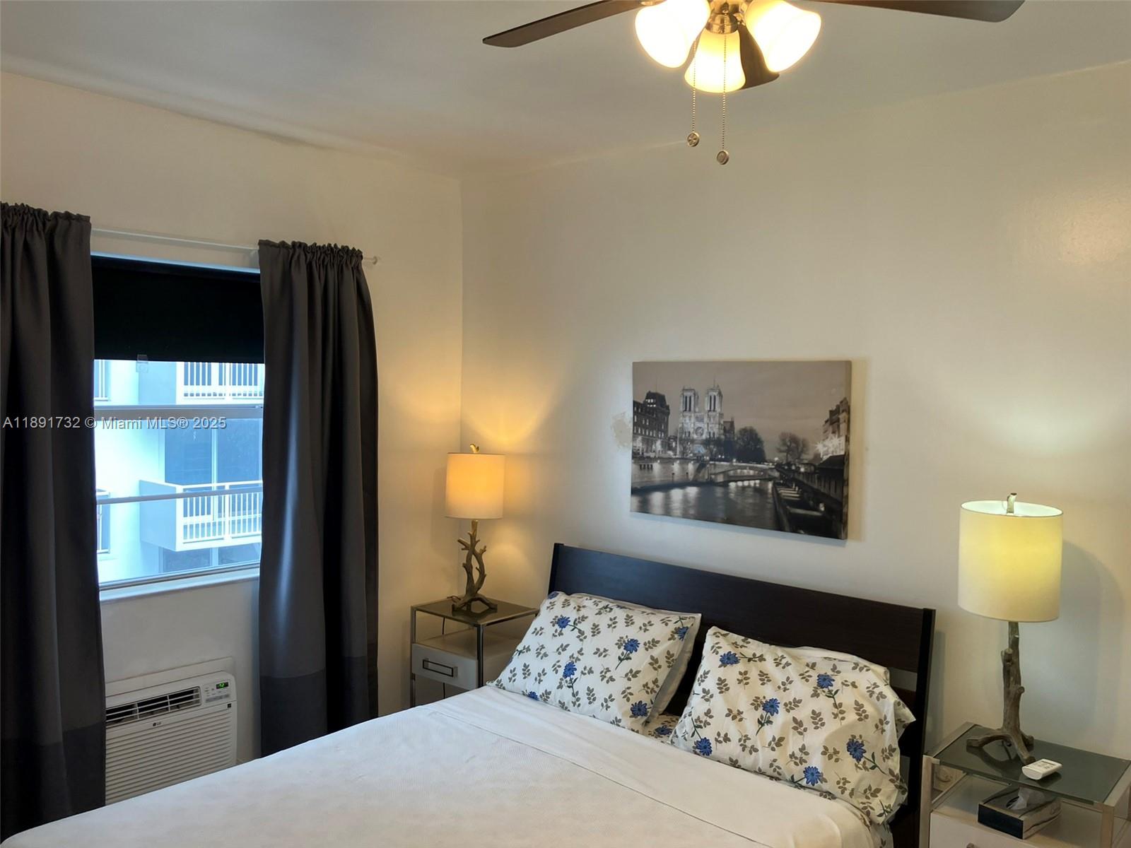 335 Ocean Drive, Unit 306 Miami Beach, FL 33139 - Photo 13 of 34 a bedroom with a bed and a painting on the wall