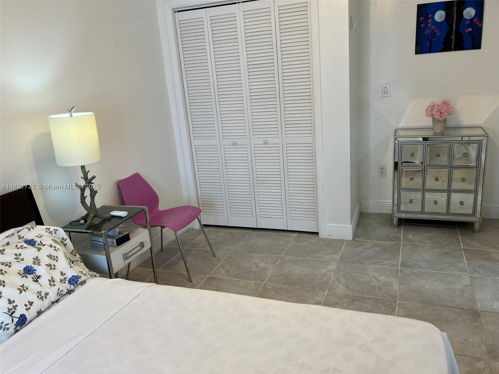 335 Ocean Drive, Unit 306 Miami Beach, FL 33139 - Photo 16 of 34 a bedroom with a bed and furniture