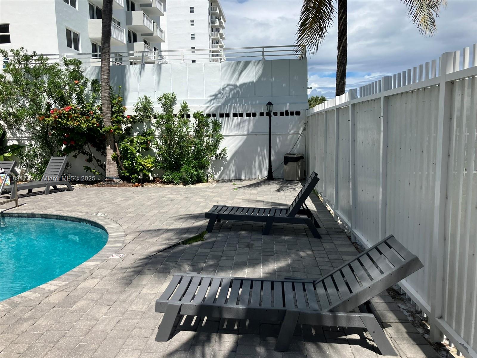 335 Ocean Drive, Unit 306 Miami Beach, FL 33139 - Photo 33 of 34 a view of a patio with a table chairs and potted plants