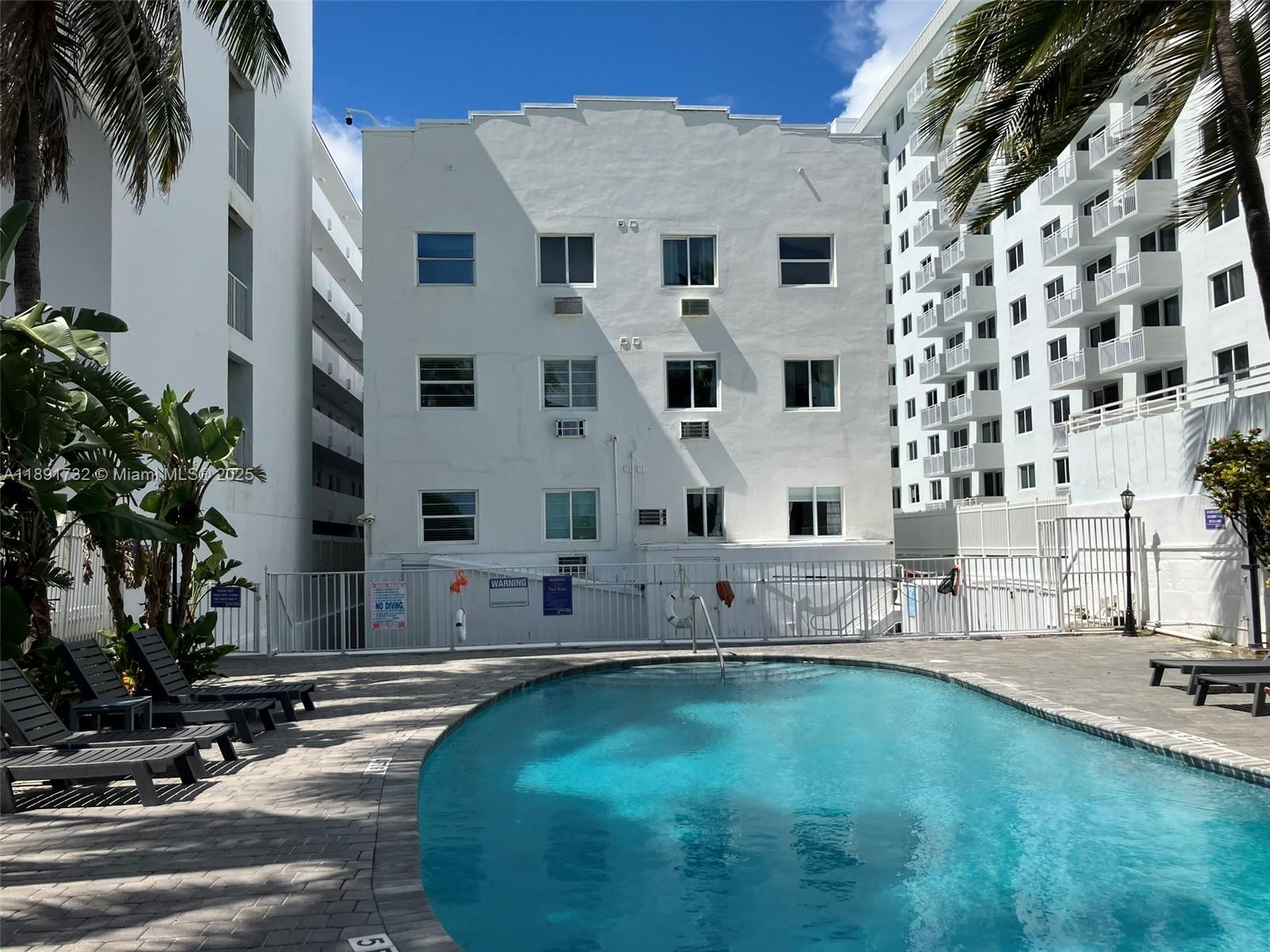 335 Ocean Drive, Unit 306 Miami Beach, FL 33139 - Photo 34 of 34 a swimming pool with outdoor seating and yard