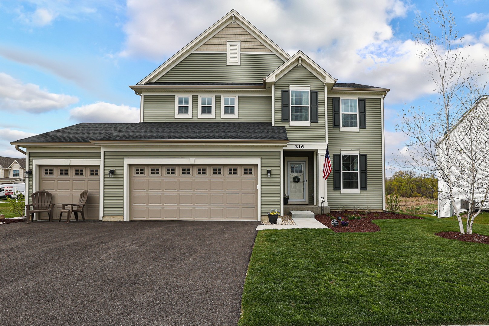 216 North Barry Road South Elgin, IL 60177 - Photo 1 of 50 a front view of a house with a garden and yard