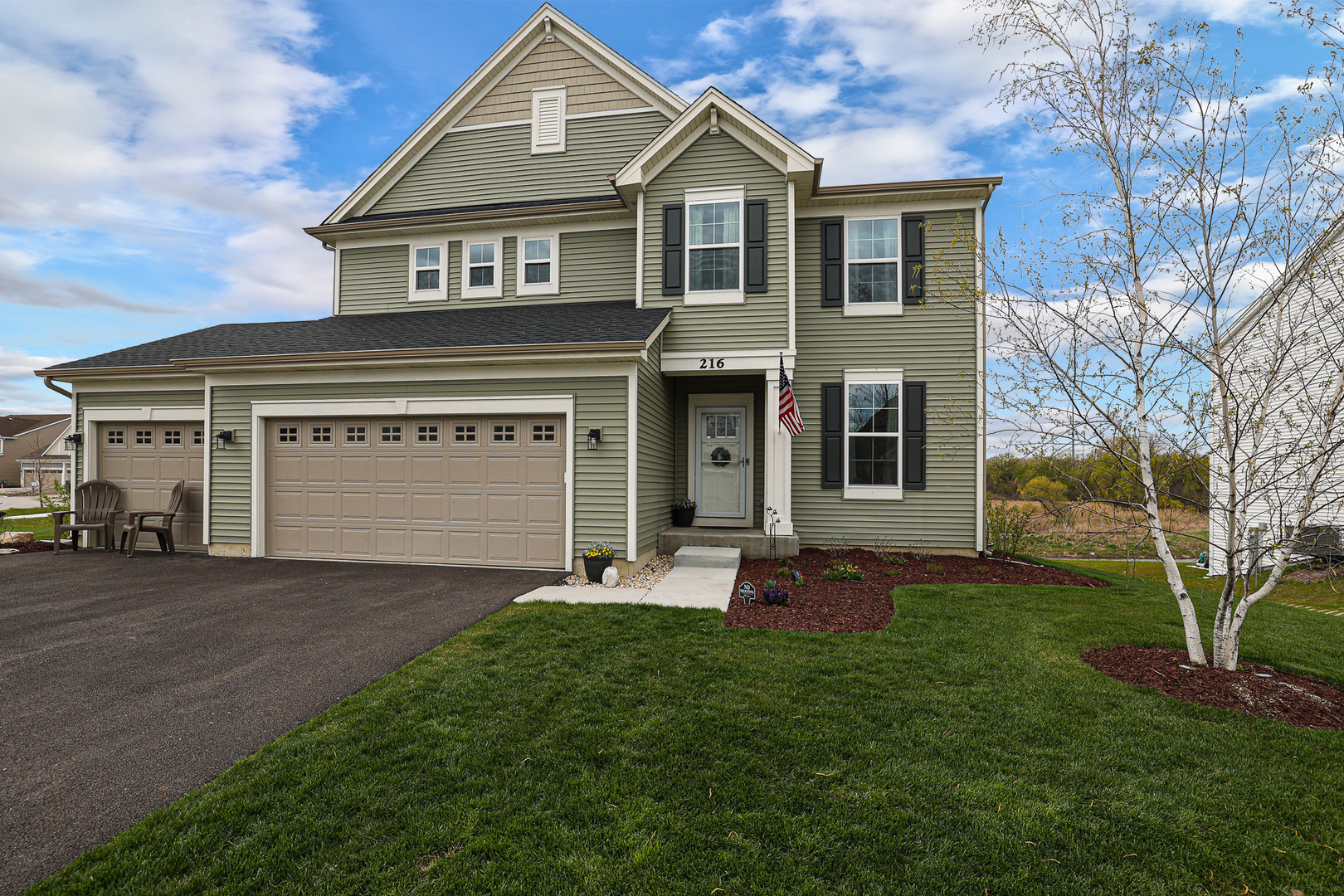 216 North Barry Road South Elgin, IL 60177 - Photo 2 of 50 a front view of a house with a yard and garage
