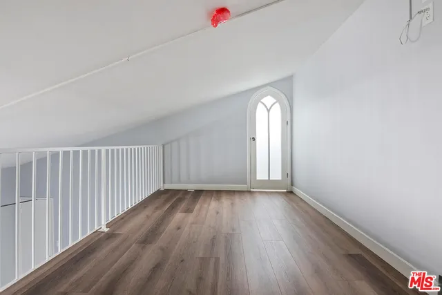 a view of a livingroom with wooden floor and window