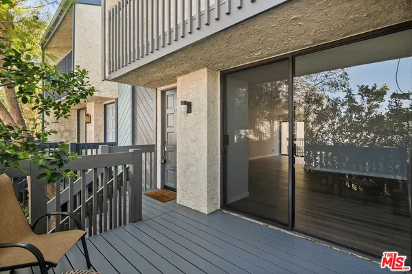 a view of a porch with wooden floor