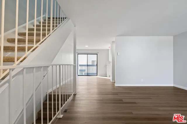 a view of an entryway with wooden floor
