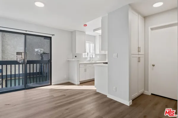 a view of a kitchen with wooden floor