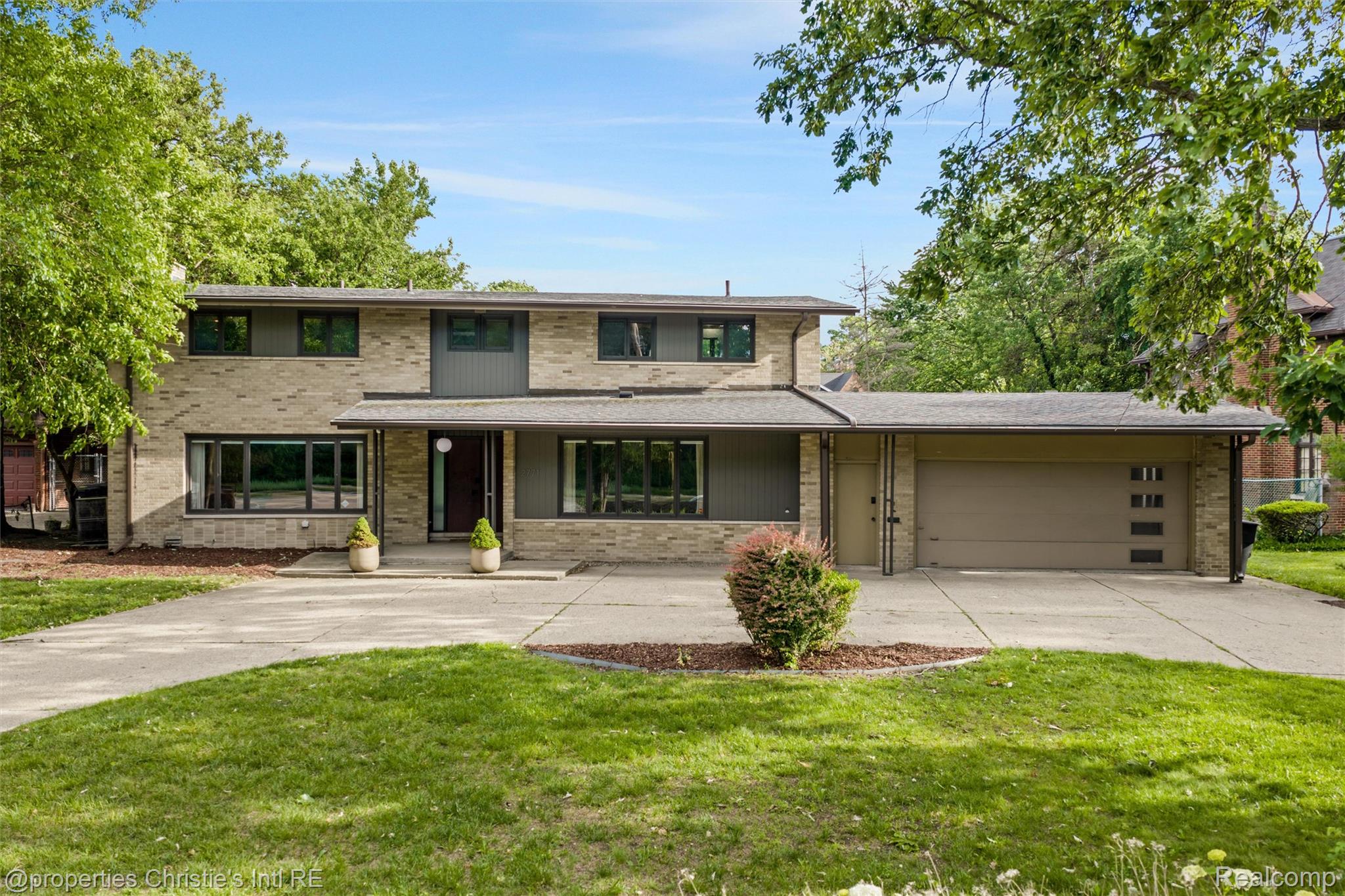 Contemporary stone and siding exterior with an integrated garage