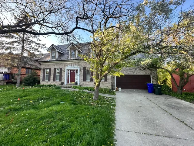 a view of house with a yard