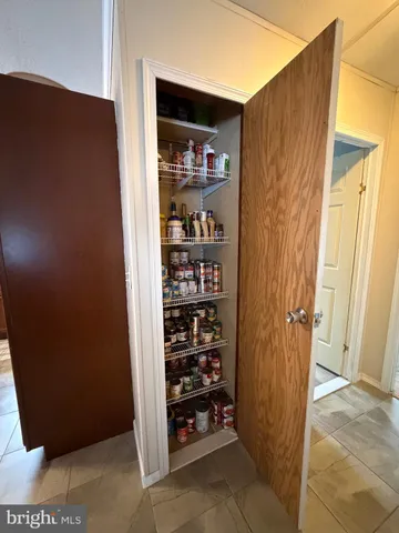 a bedroom with bed and a chandelier