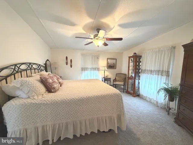 a bedroom with bed and a chandelier
