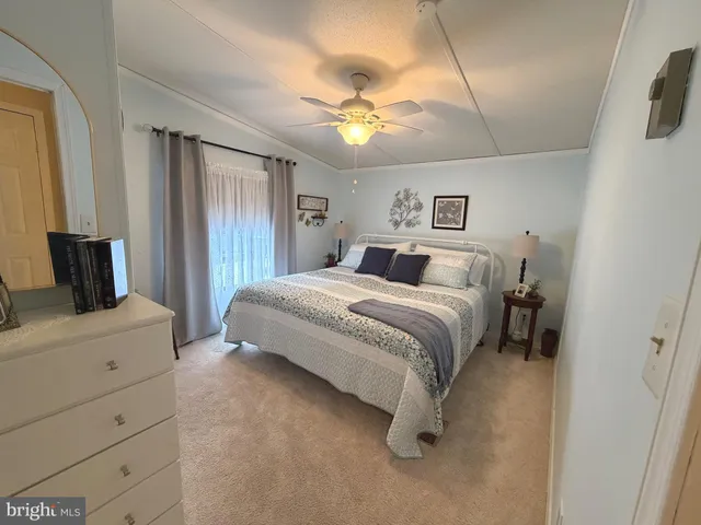 a bathroom with a granite countertop sink toilet a mirror a vanity and shower