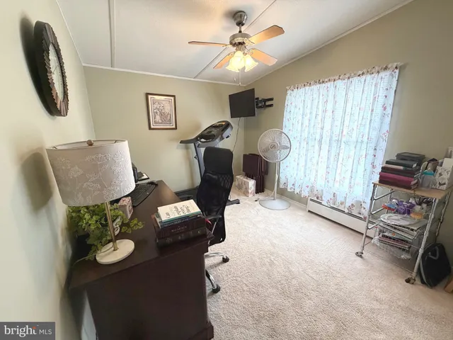 a view of a kitchen with fridge and workspace