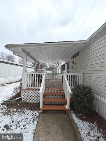 a living room with furniture a flat screen tv and a window