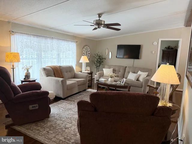 a living room with furniture a chandelier and a window