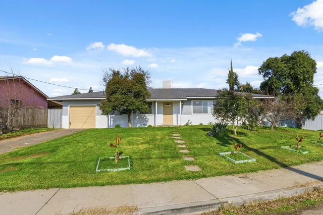 a front view of a house with a yard