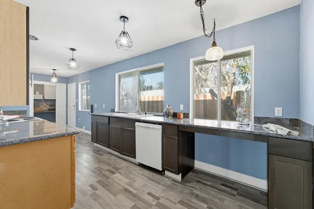 a large kitchen with kitchen island a sink counter space appliances and a window