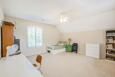 a bedroom with furniture and a window
