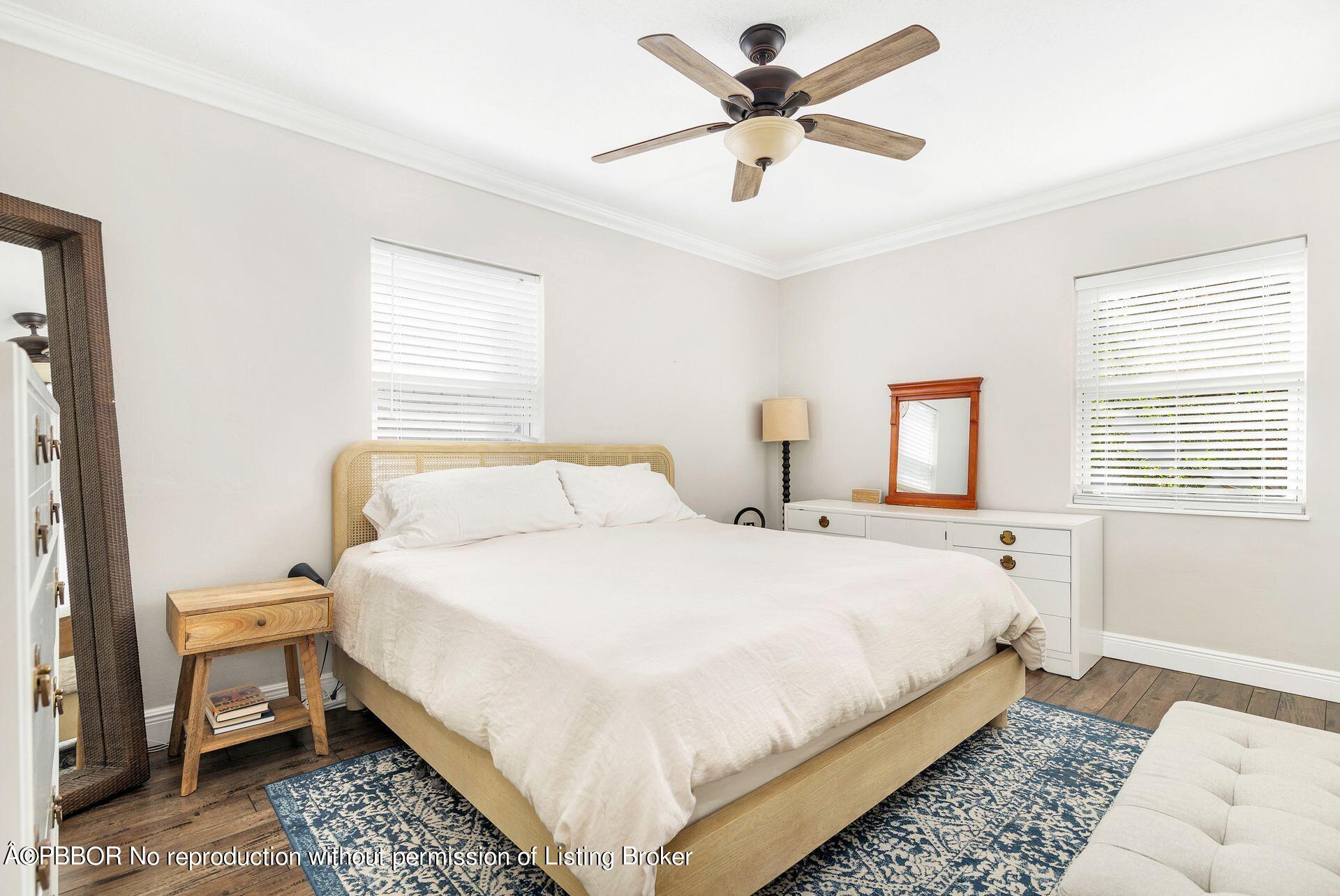 356 Potter Road West Palm Beach, FL 33405 - Photo 13 of 24 a bedroom with a bed and a chandelier