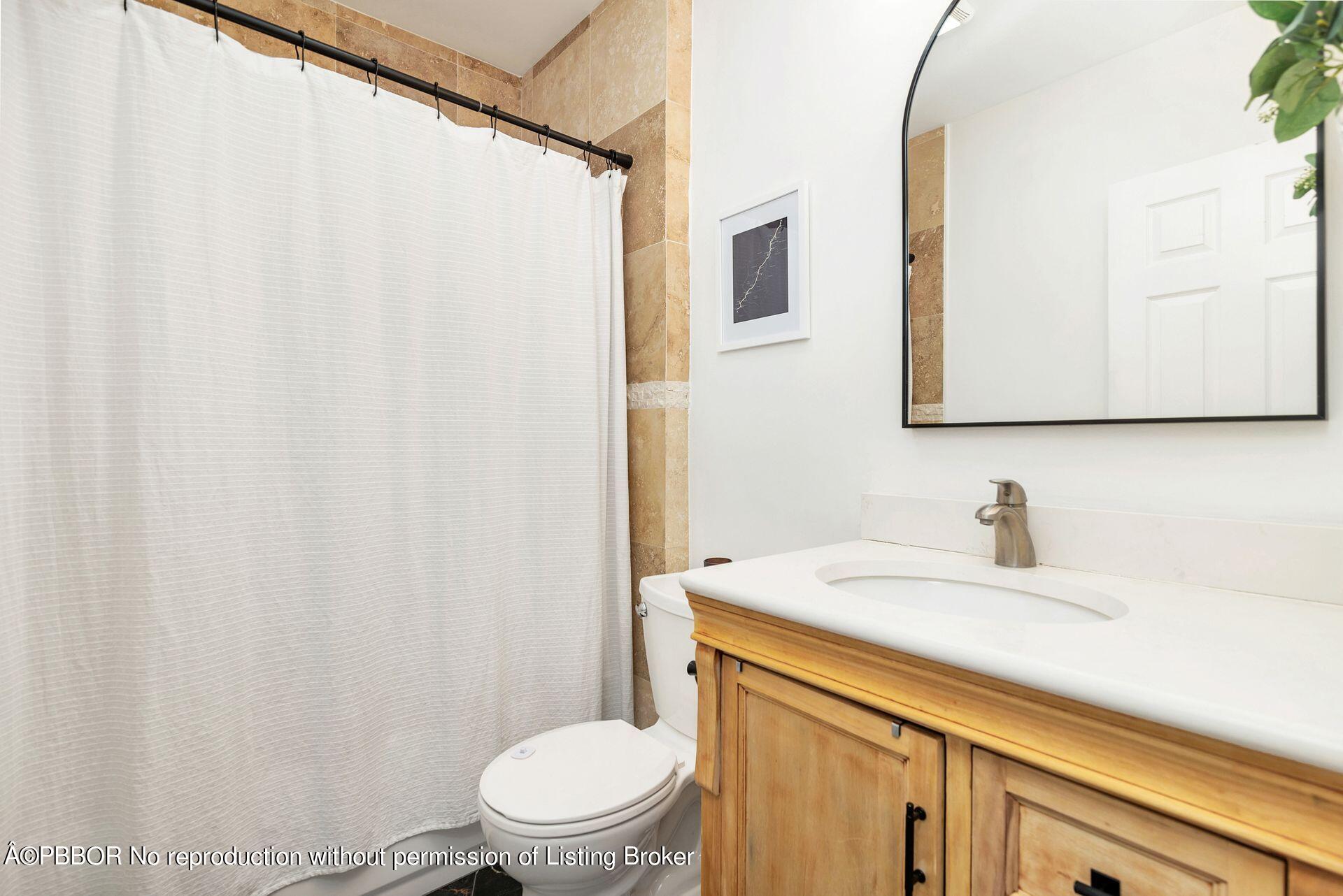 356 Potter Road West Palm Beach, FL 33405 - Photo 14 of 24 a bathroom with a sink a toilet and a mirror