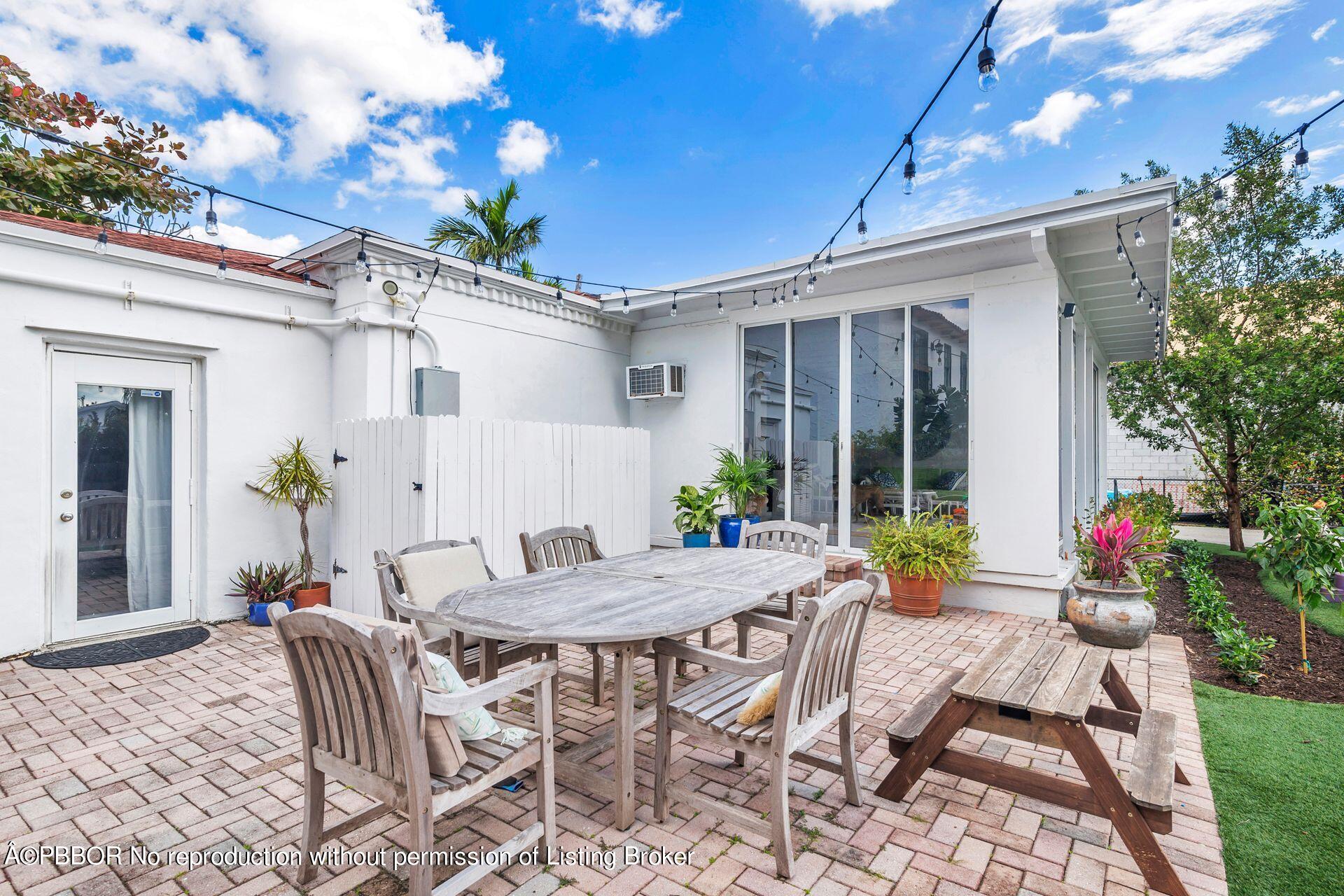 356 Potter Road West Palm Beach, FL 33405 - Photo 18 of 24 a view of a patio with a table and chairs and potted plants
