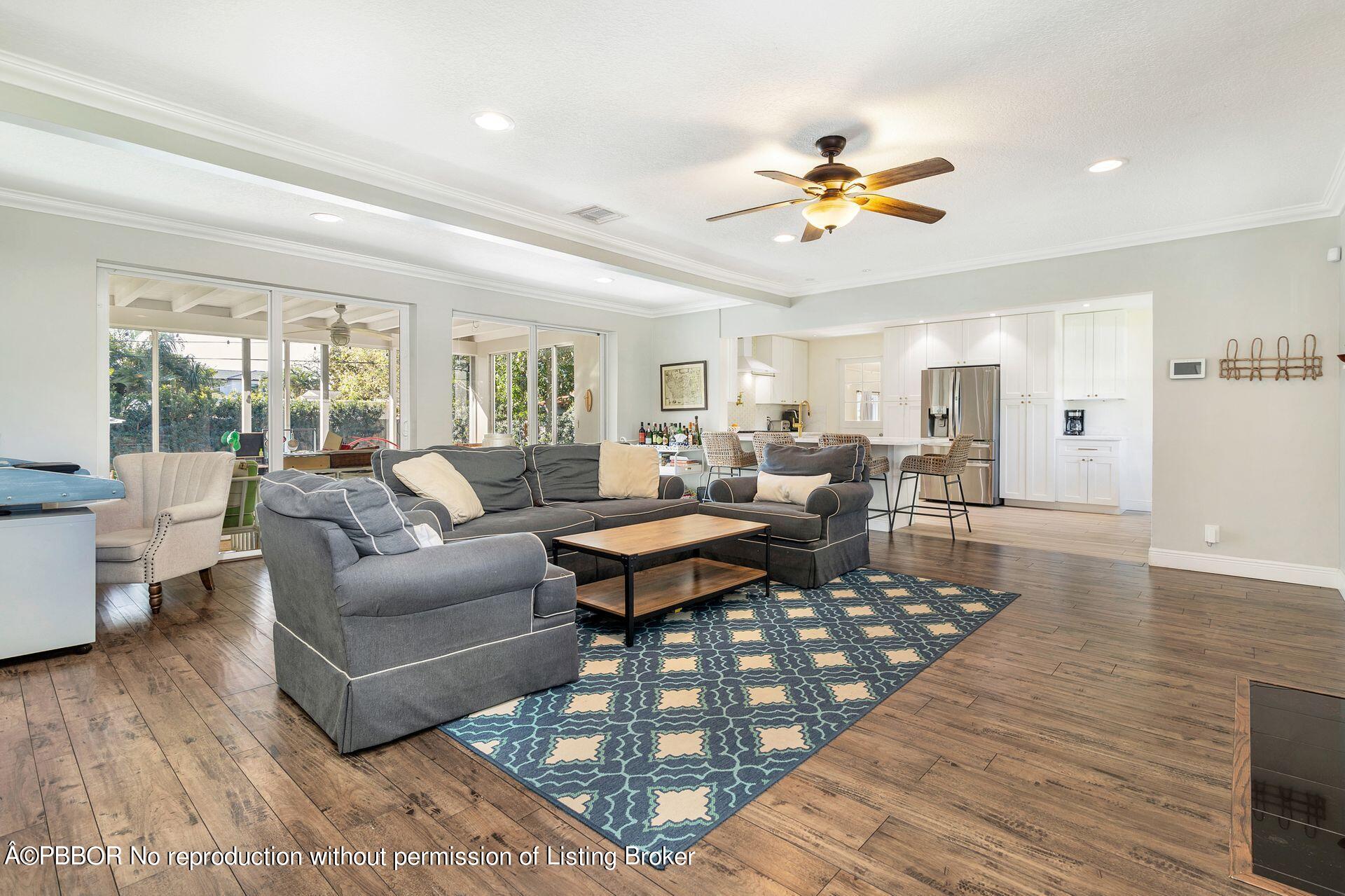 356 Potter Road West Palm Beach, FL 33405 - Photo 3 of 24 a living room with furniture a chandelier and a rug