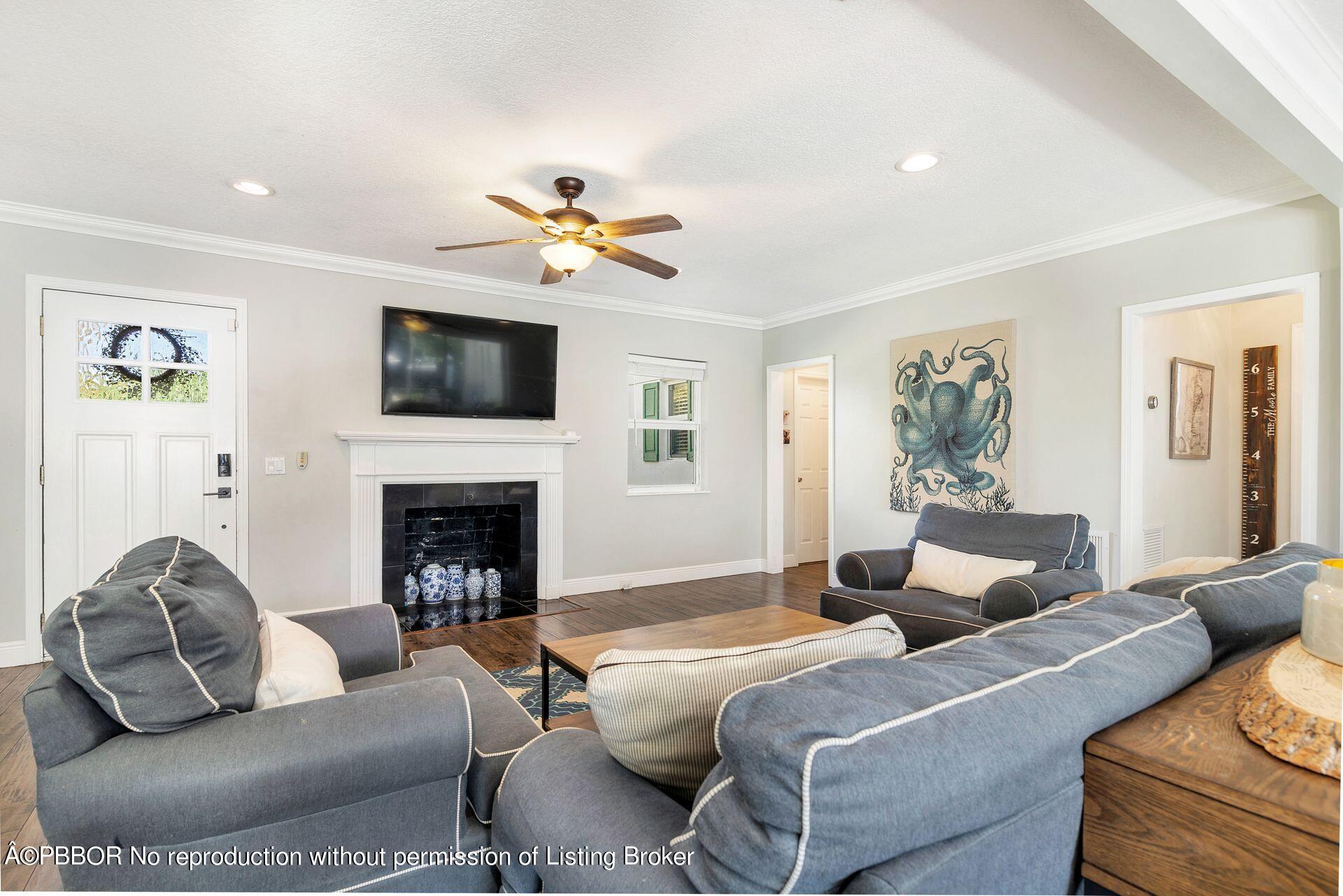 356 Potter Road West Palm Beach, FL 33405 - Photo 6 of 24 a living room with furniture a fireplace and a flat screen tv
