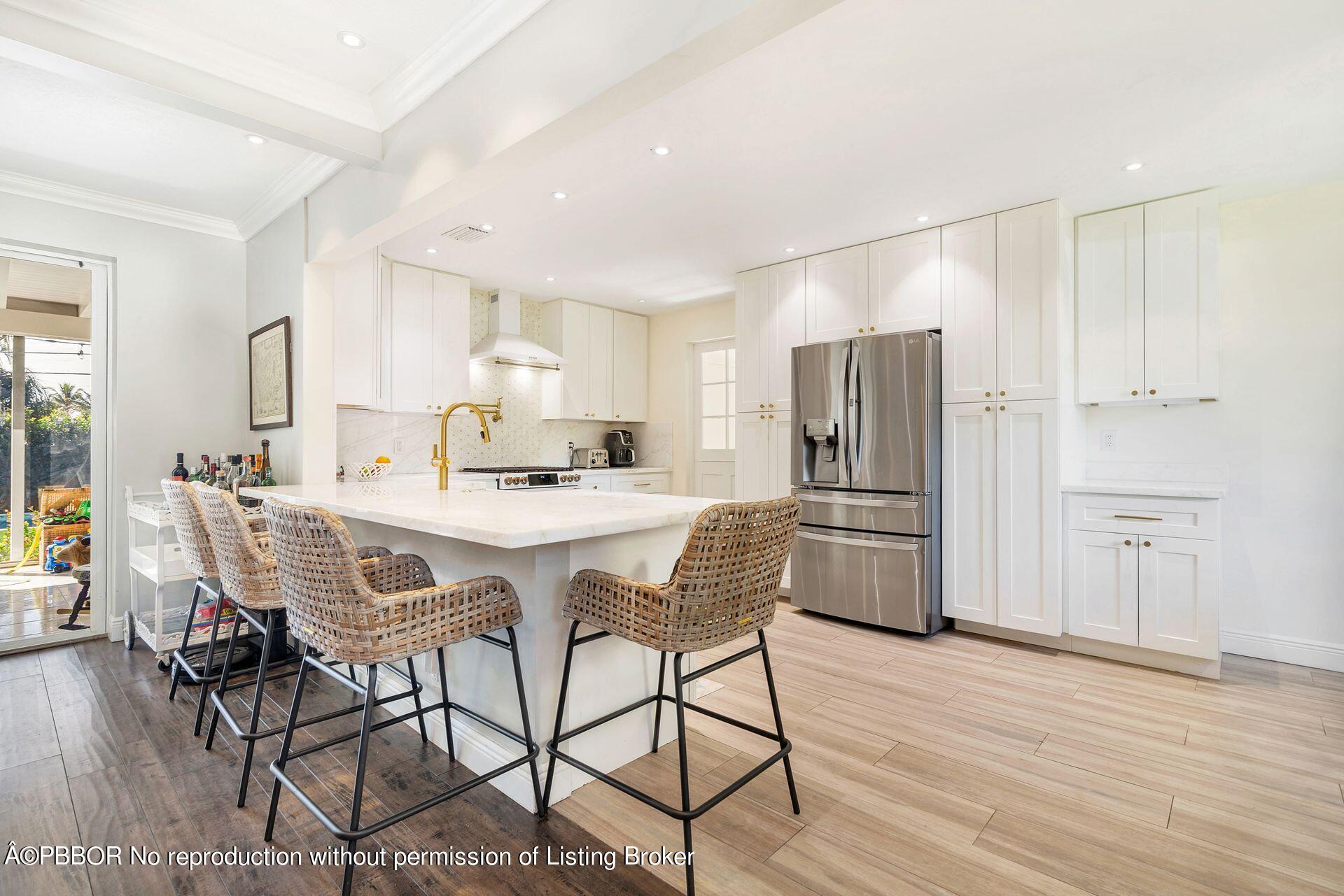 356 Potter Road West Palm Beach, FL 33405 - Photo 7 of 24 a kitchen with stainless steel appliances granite countertop a dining table chairs refrigerator and cabinets