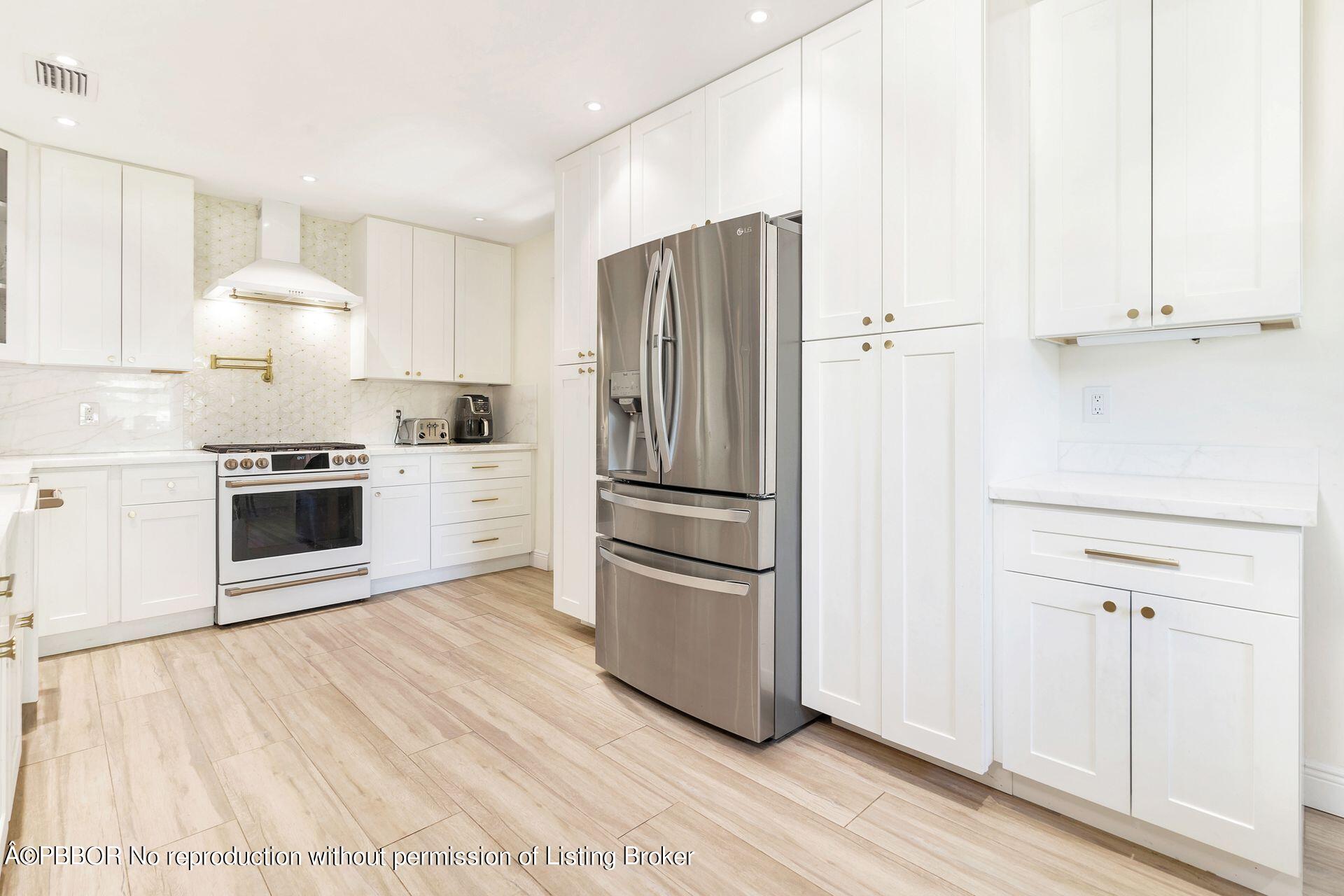 356 Potter Road West Palm Beach, FL 33405 - Photo 8 of 24 a kitchen with stainless steel appliances a refrigerator sink and microwave
