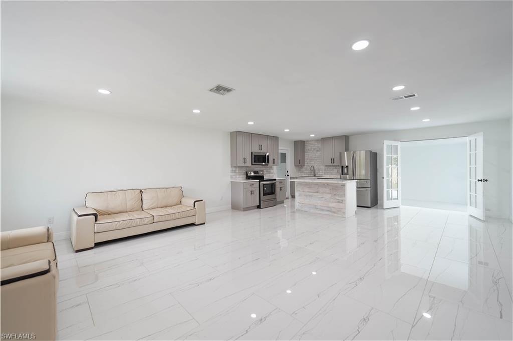 Unfurnished living room with sink