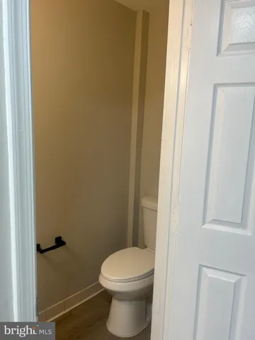 a white toilet sitting next to a shower