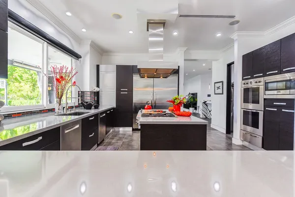a view of kitchen with kitchen island stainless steel appliances a stove and center island