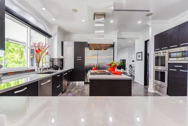 a view of kitchen with kitchen island stainless steel appliances a stove and center island