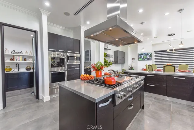 a kitchen with stainless steel appliances granite countertop a stove and a refrigerator