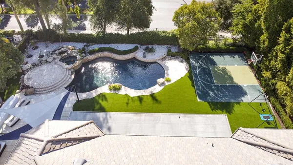 an aerial view of a house with yard swimming pool and outdoor seating