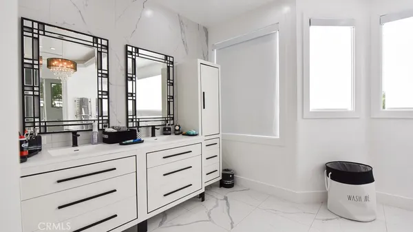 a bathroom with a double vanity sink mirror bathtub and toilet