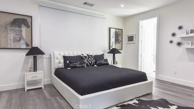 a bedroom with a bed and a night stand