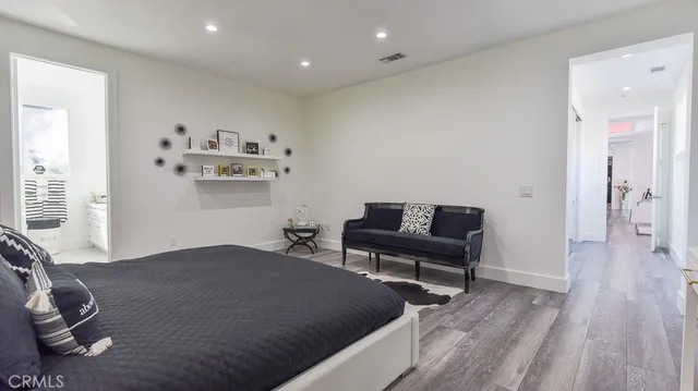 a bedroom with furniture and a wooden floor