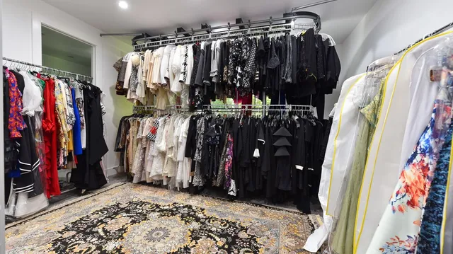 a view of walk in closet with clothes