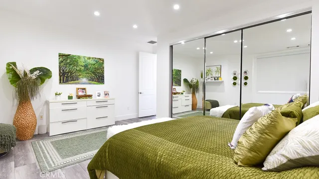 a bedroom with a bed and a flat screen tv