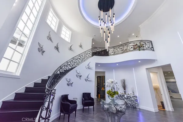 a view of a livingroom with furniture stairs and wooden floor