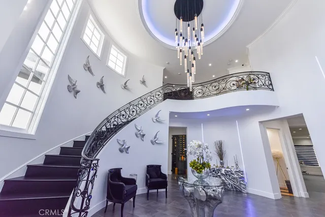 a view of a livingroom with furniture stairs and wooden floor