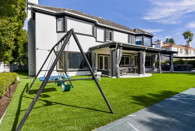 a view of a house with a yard patio and a slide