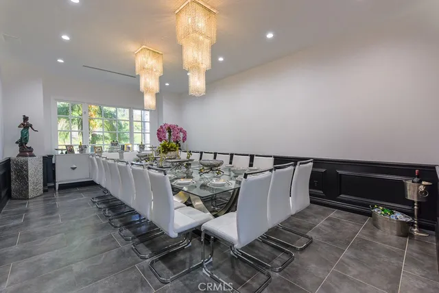 a dining room with furniture and a chandelier