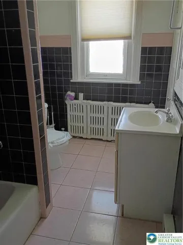 a bathroom with a bathtub sink and window
