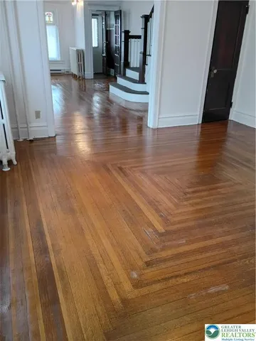 a view of a hallway with wooden floor