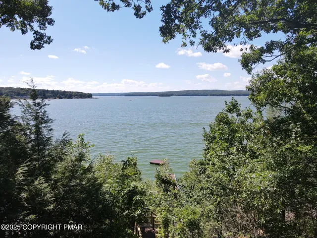 a view of kitchen with refrigerator and wooden floor
