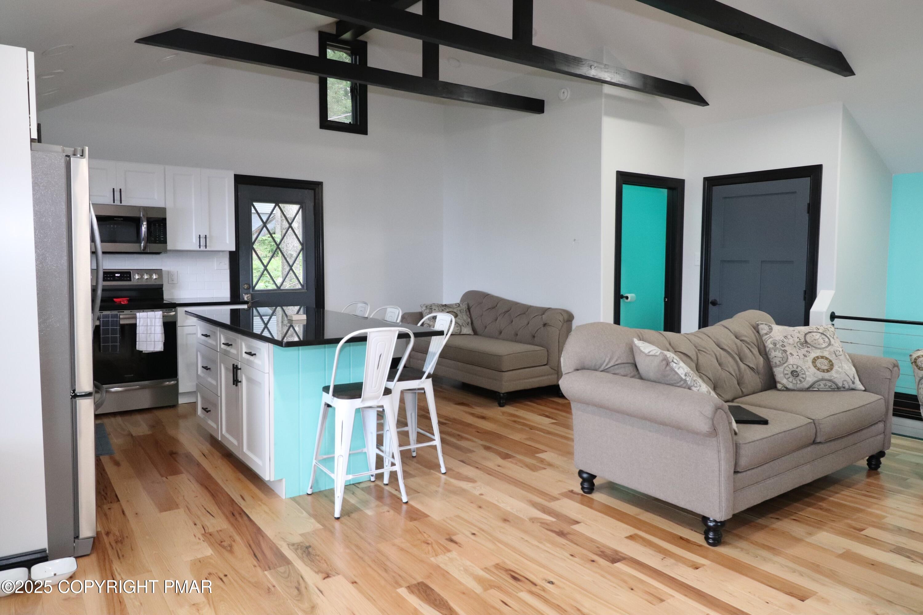 101 Antler Rdg Court Hawley, PA 18428 - Photo 22 of 36 a living room with furniture a flat screen tv and a table
