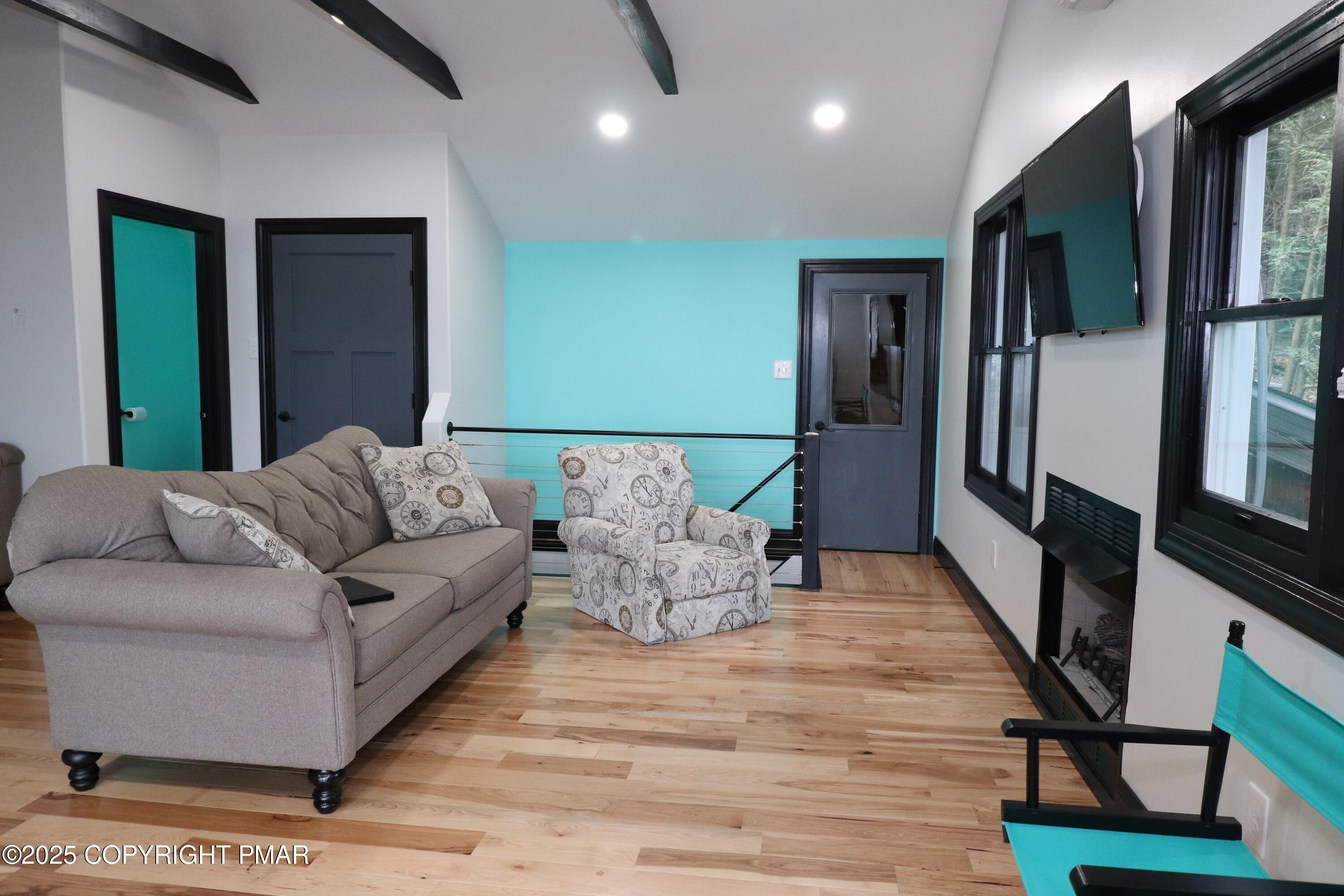 101 Antler Rdg Court Hawley, PA 18428 - Photo 23 of 36 a living room with furniture fireplace and a flat screen tv