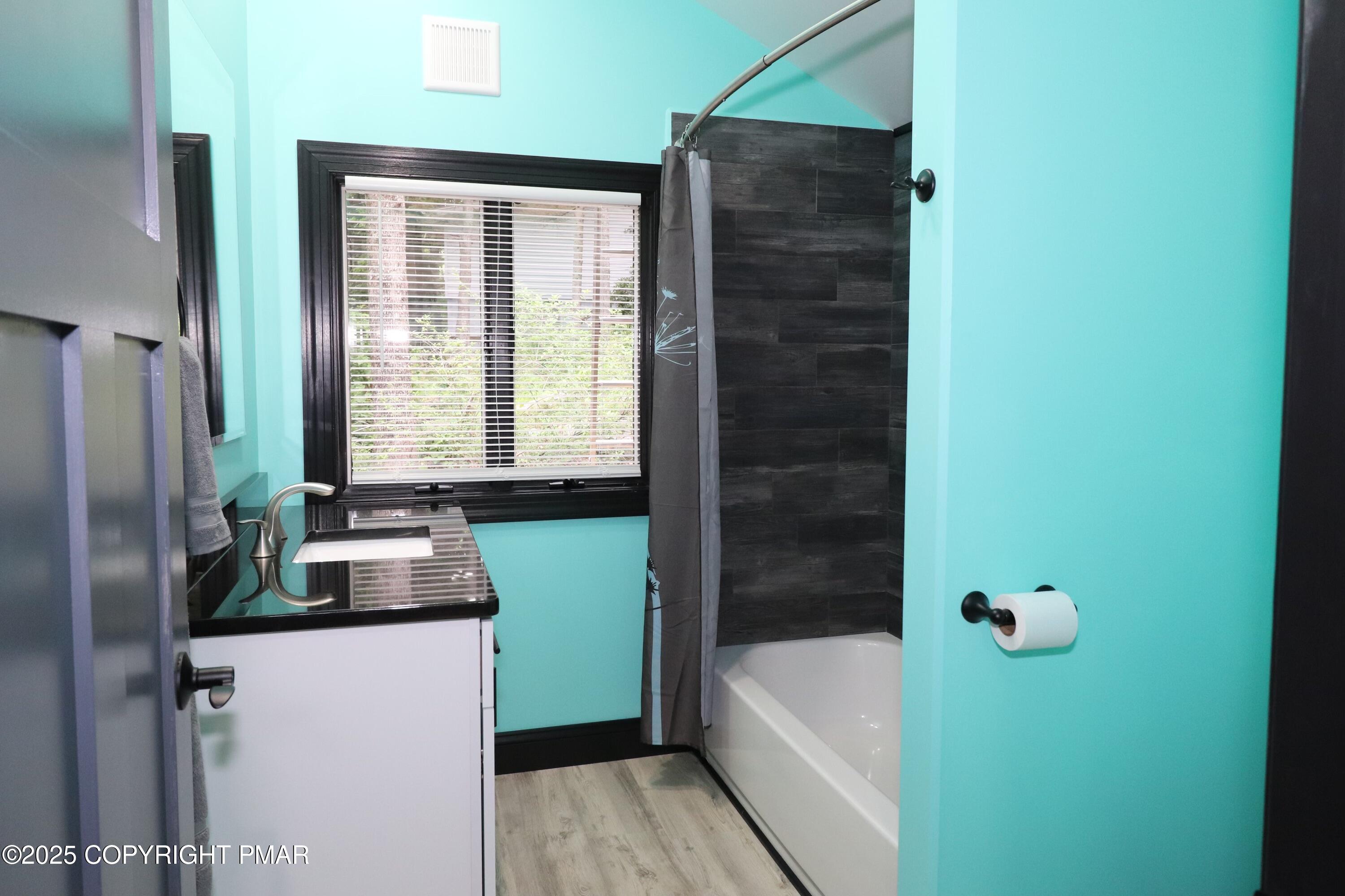101 Antler Rdg Court Hawley, PA 18428 - Photo 24 of 36 a bathroom with a bathtub sink and window