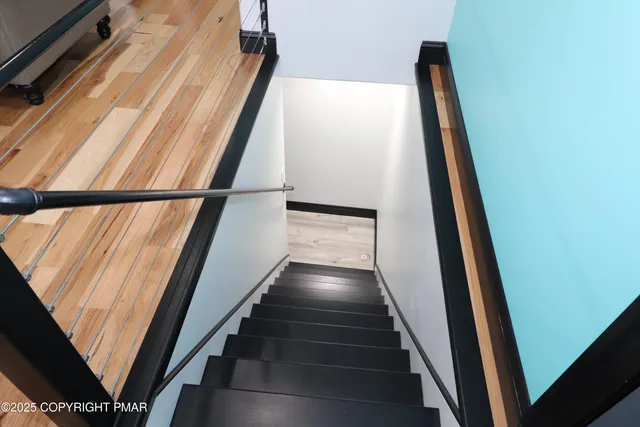 a bedroom with a bed and painting on the wall